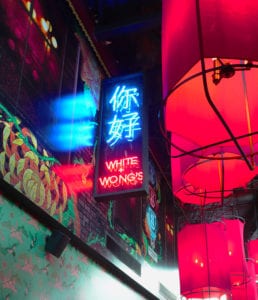 White and Wongs neon signage in laneway with red lanterns