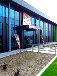 Mighty Ape exterior building signage with brand fascia and image and flags - by Signwise Auckland