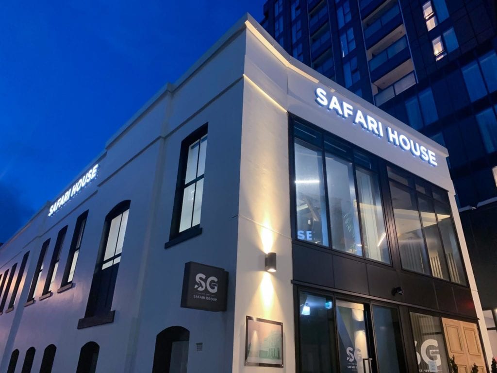 Signwise Auckland manufactured corporate building exterior signage for Safari House lit up at night