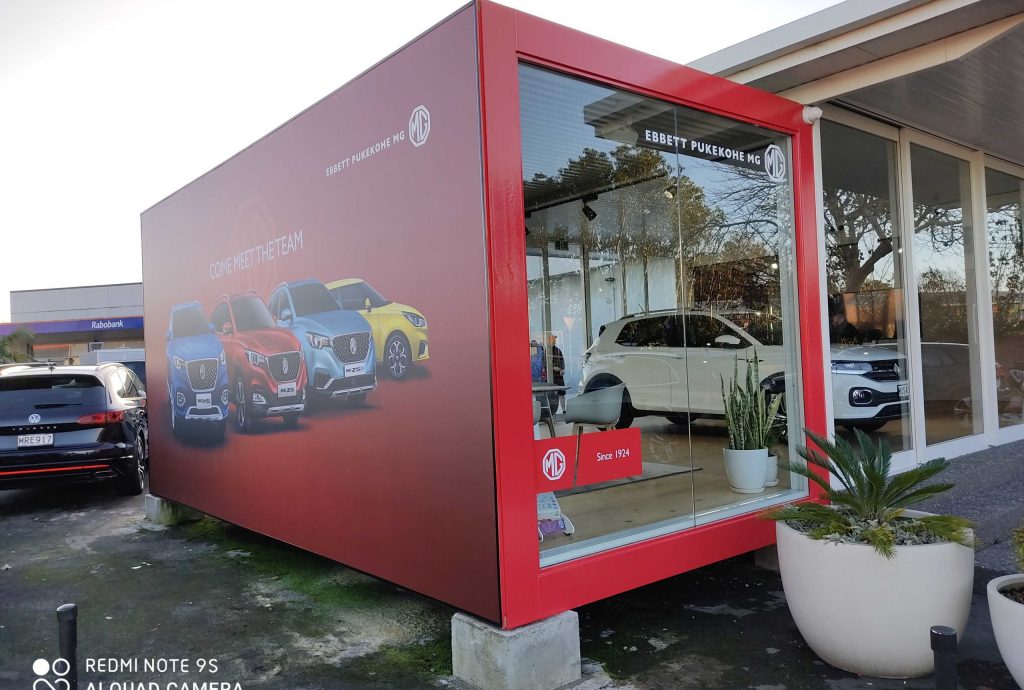 Exterior Signage - Brand Signage - MG motors showroom extension wrapped in signage with cars images - Signwise Auckland