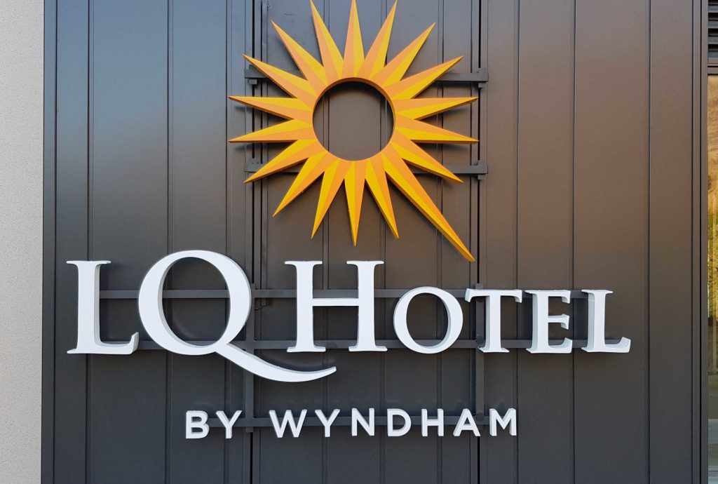 Exterior Signage - Fascia Sign for LQ hotel with sun logo - Signwise Auckland