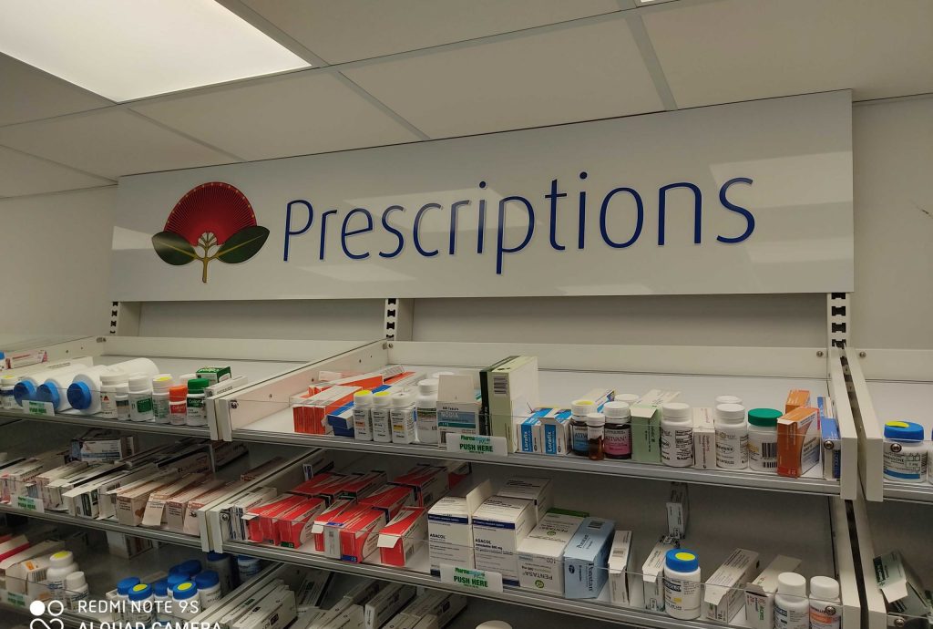 Interior Signage​ - POS Signs pharmacy prescription large white sign with medicines on shelves - Signwise Auckland