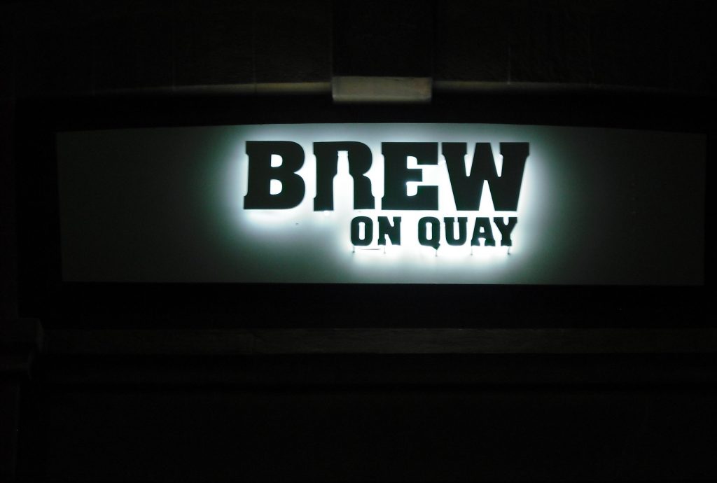 Signwise Auckland Hospitality brand signage for Brew on Quay lit up at night